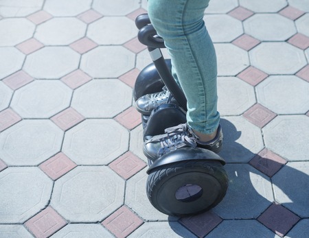 woman legs ride gyroscooter or hoverboard