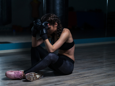 Upset young fighter boxer after loosing fightの写真素材