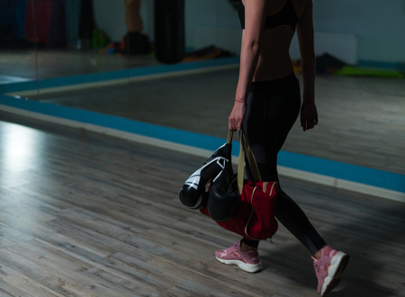 Young fighter boxer girl is going for training.の写真素材