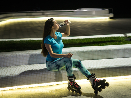 A girl is drinking water from plastic bottleの写真素材