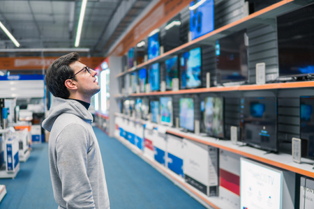 customer choosing large fridges in domestic appliances sectionの写真素材