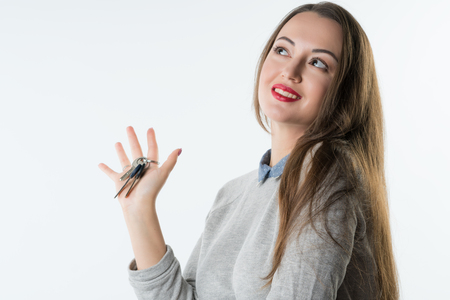 smiling business woman or real estate agent showing keysの写真素材