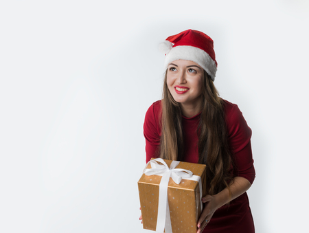 woman wearing red santa claus hat with giftの写真素材