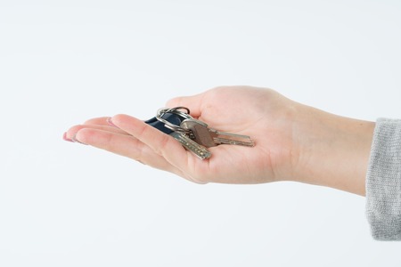 smiling business woman or real estate agent showing keysの写真素材
