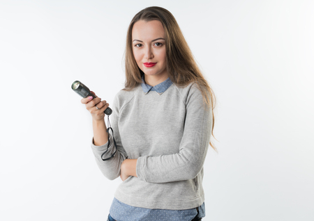 Woman holding an electrical torch flashlightの写真素材