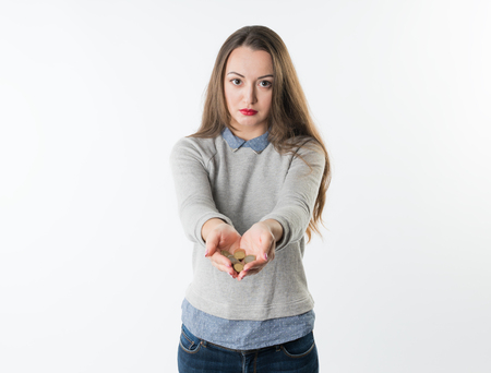 Woman hands holding euro coins and giving them to cameraの写真素材