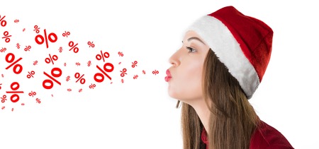 woman wearing red santa claus hat blows discount percentagesの写真素材