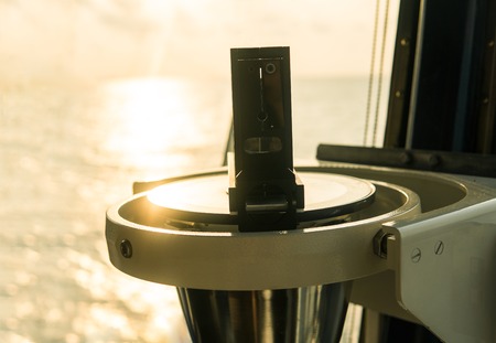 Close up of nautical marine magnetic compass on yacht or boatの写真素材