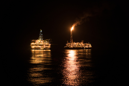 FPSO tanker vessel near Oil Rig at night. Offshore oil and gas industryの写真素材