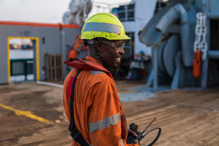 Seaman AB or Bosun on deck of offshore vessel or ship , wearing PPEの写真素材