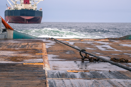 AHTS vessel doing static tow tanker lifting. Ocean tug jobの写真素材