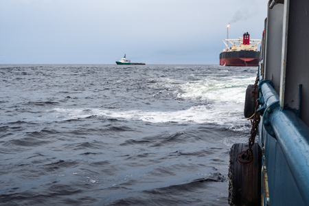 View from deck of AHTS ocean tug. Tanker vessel on background.の写真素材