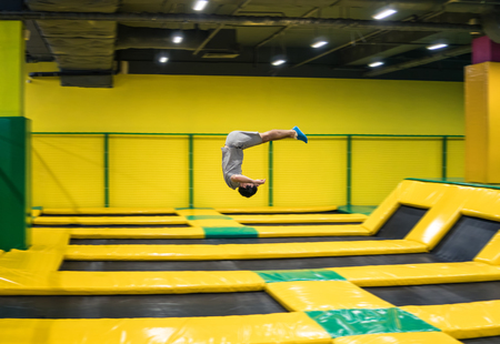 trampoline jumper performs acrobatic exercises on the trampolineの写真素材