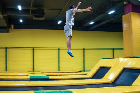 trampoline jumper performs acrobatic exercises on the trampolineの写真素材