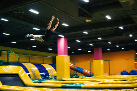 Trampoline jumper performs acrobatic exercises on the trampolineの写真素材