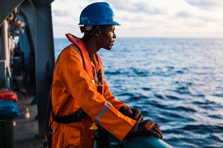 Seaman AB or Bosun on deck of vessel or ship , wearing PPEの写真素材