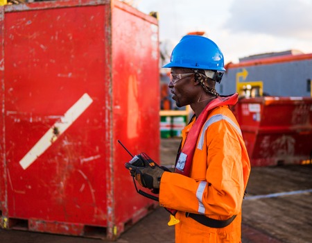 Seaman AB or Bosun on deck of offshore vessel or ship , wearing PPE