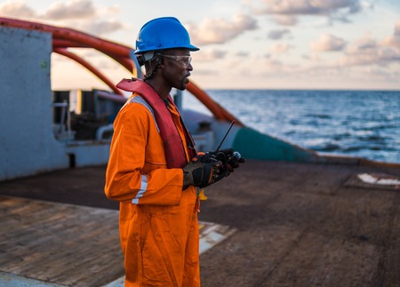 Seaman AB or Bosun on deck of vessel or ship , wearing PPEの写真素材