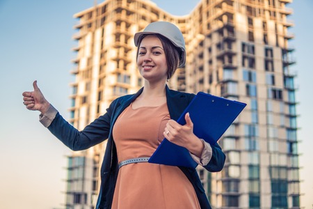 beatiful business woman engineer is standing with plan papers.の写真素材