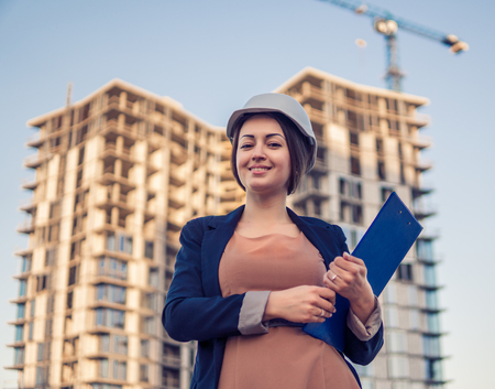 beatiful business woman engineer is standing with plan papers.の写真素材