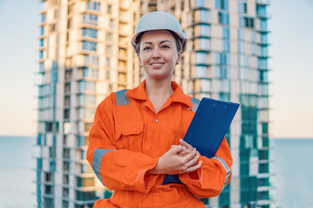 beatiful business woman engineer wearing orange coverallの写真素材