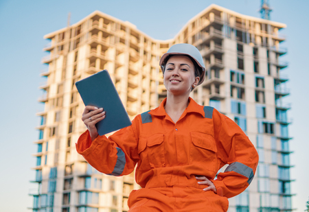 beatiful business woman engineer wearing orange coverallの写真素材