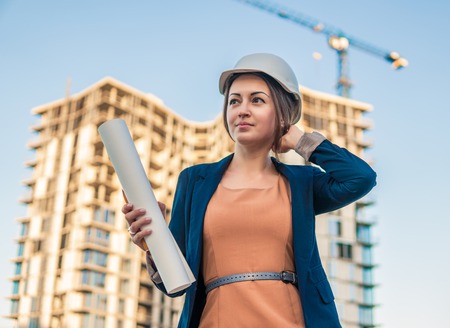 beatiful business woman engineer is standing with plan papers.の写真素材