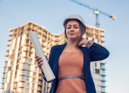 beatiful business woman engineer is standing with plan papers.の写真素材