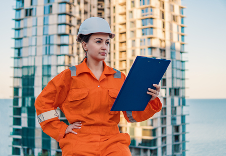 beatiful business woman engineer wearing orange coverallの写真素材