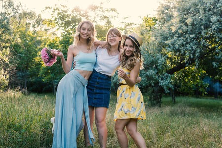 Three of girls friends outdoor in the park or forestの写真素材