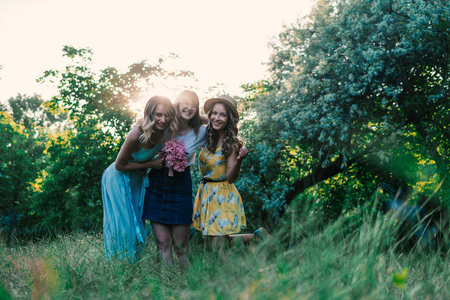 Three of girls friends outdoor in the park or forestの写真素材