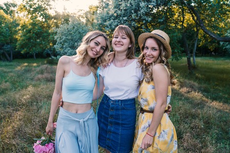 Three of girls friends outdoor in the park or forestの写真素材