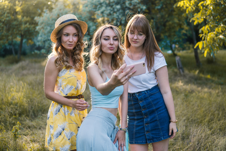 Group of girls friends take selfie photoの写真素材