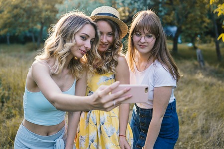 Group of girls friends take selfie photoの写真素材