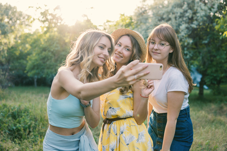 Group of girls friends take selfie photoの写真素材