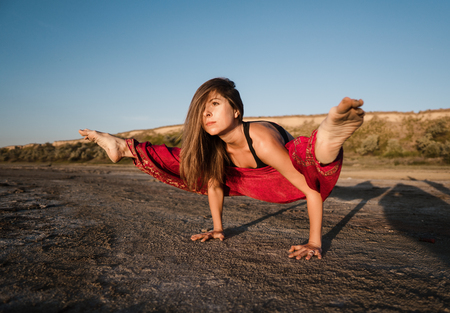 yoga woman on the beach at sunset.の写真素材