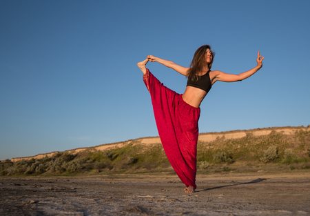 yoga woman on the beach at sunset.の写真素材