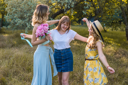 Three of girls friends outdoor in the park or forestの写真素材