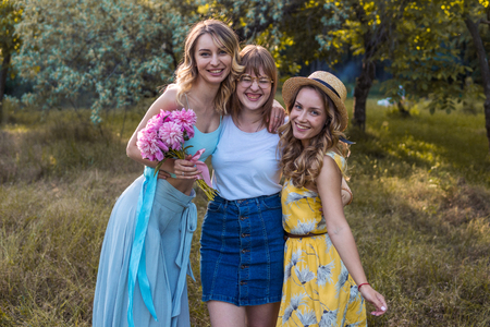 Three of girls friends outdoor in the park or forestの写真素材