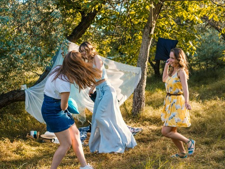 Group of girls friends making picnic outdoor.の写真素材