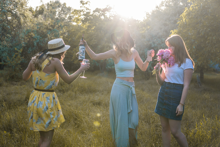 Group of girls friends making picnic outdoor. They have funの写真素材