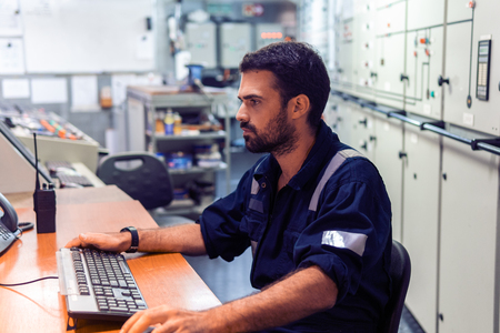 Marine engineer officer working in engine roomの写真素材