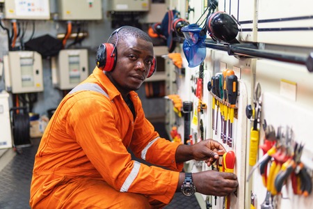 Marine engineer officer working in engine roomの写真素材