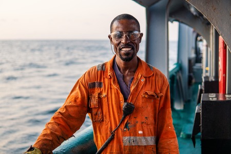Seaman AB or Bosun on deck of offshore vessel or shipの写真素材