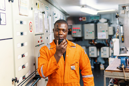 Marine engineer officer working in engine roomの写真素材