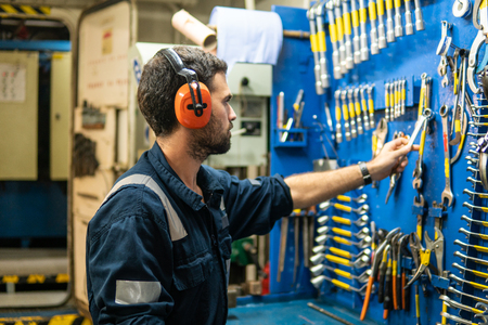 Marine engineer officer working in engine roomの写真素材