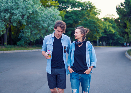 Lovely young hipster couple dating during summer sunset.の写真素材