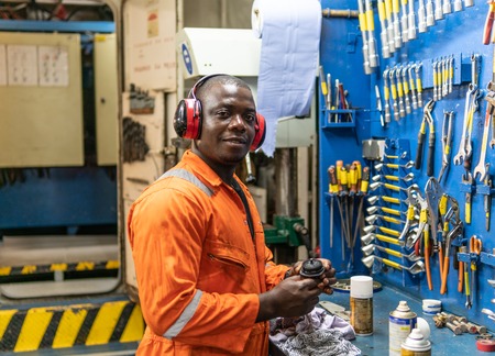 Marine engineer officer working in engine roomの写真素材