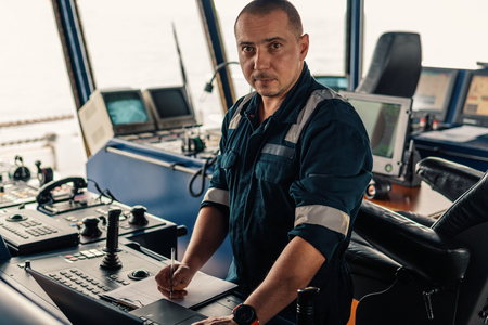 Marine navigational officer is using laptop or notebook at seaの写真素材