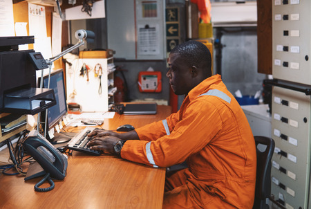 Marine engineer officer working in engine roomの写真素材